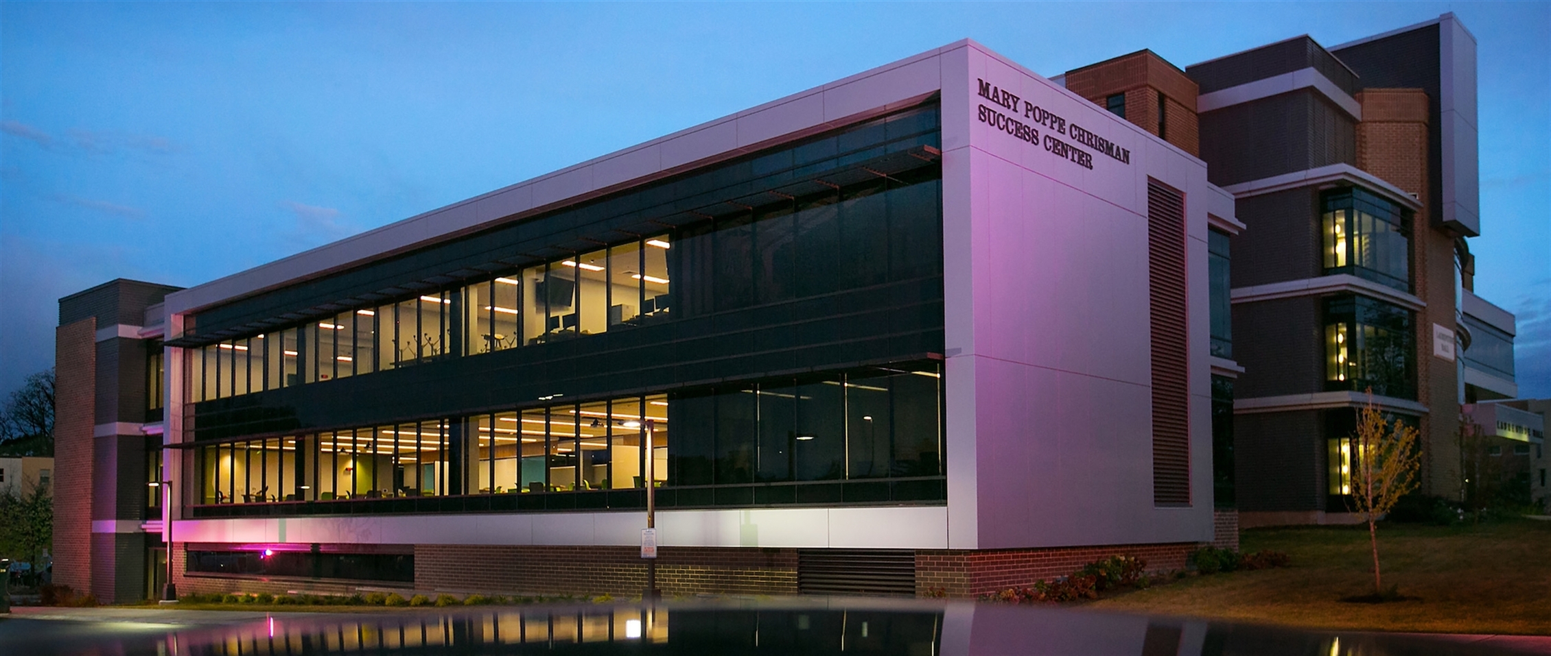 Picture of The Mary Poppe Chrisman Student Success Center at night.