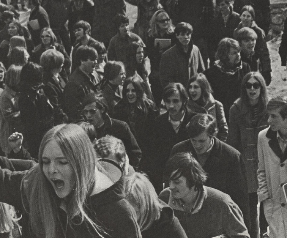 Students shout and raise their arms in protest.