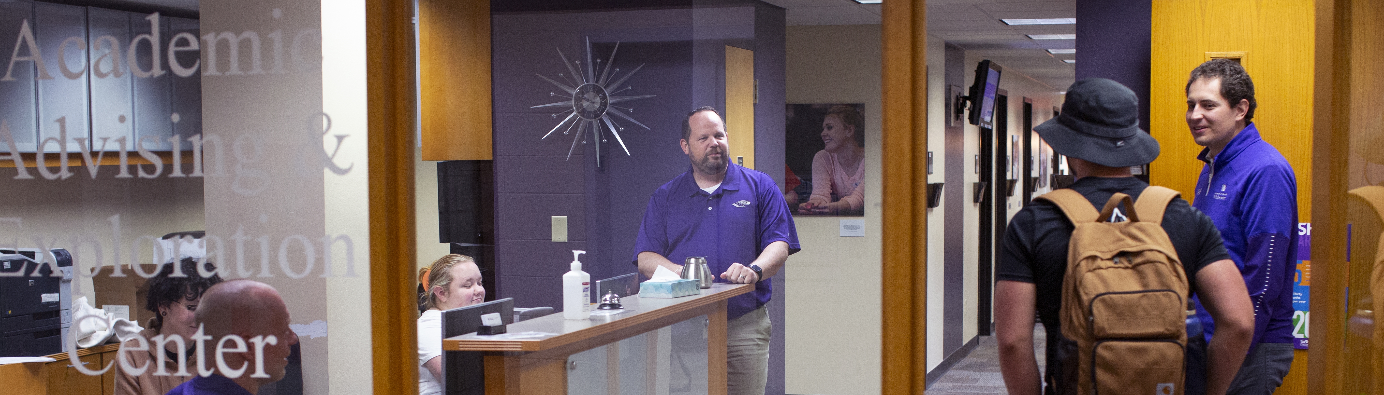 Students and staff talking in academic advising and exploration center