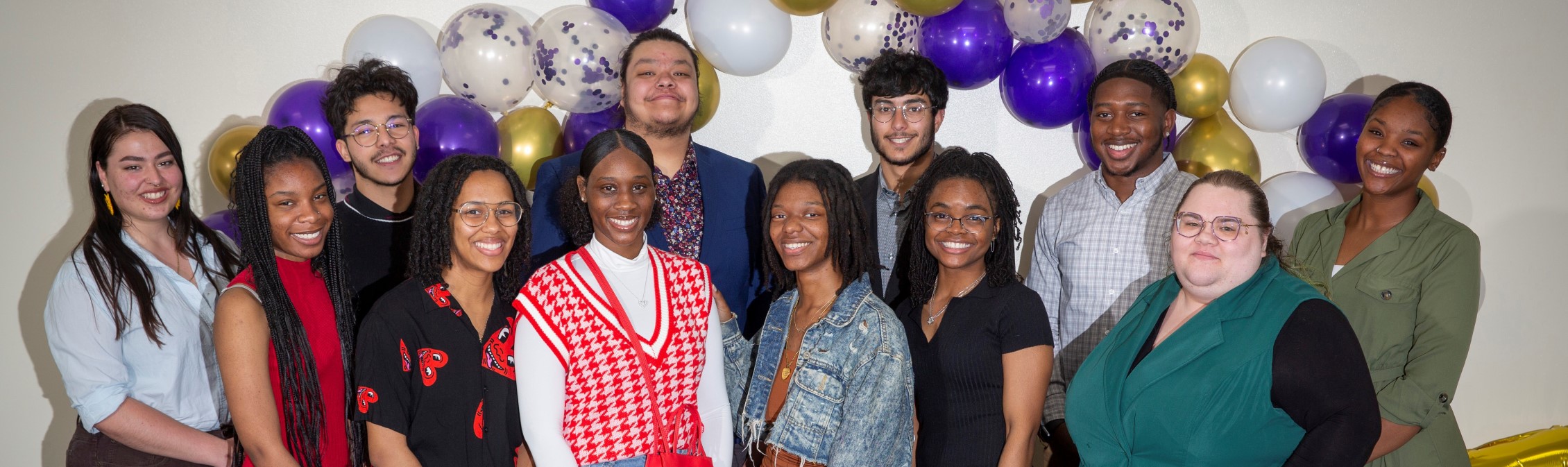 A group of people smile at the camera.