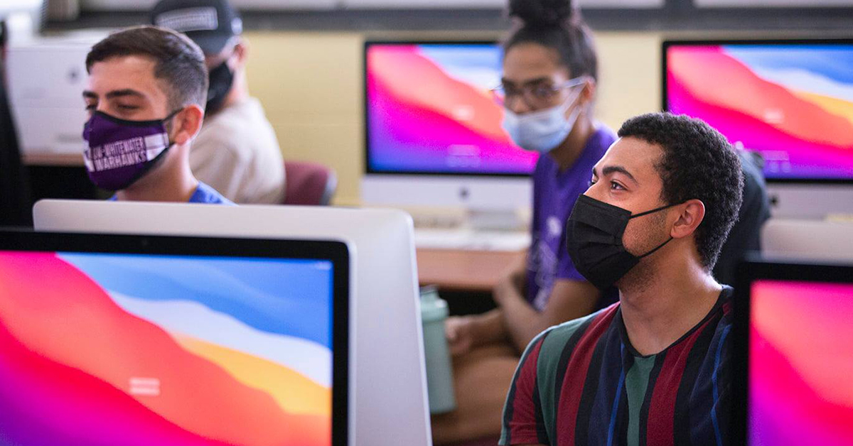 Students working on iMac computers