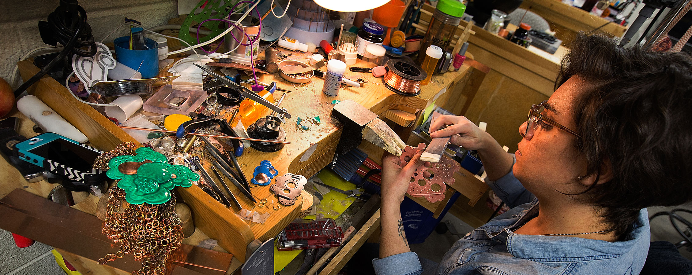 Art and design student works on a sculpture in the studio on the University of Wisconsin Whitewater campus