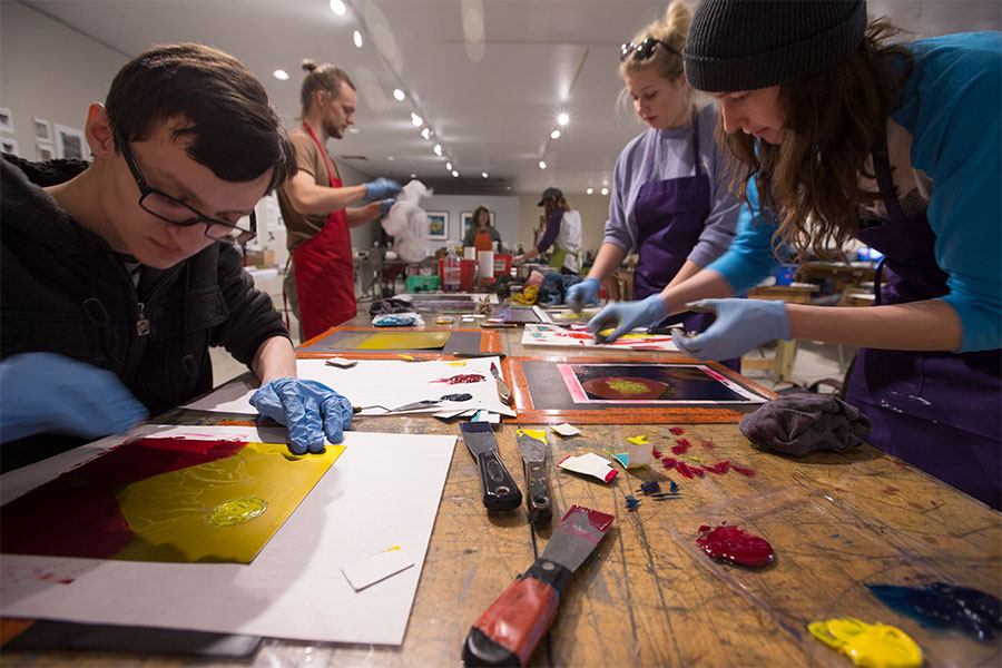 Art and design students explain their artwork in the art gallery at the University of Wisconsin Whitewater.