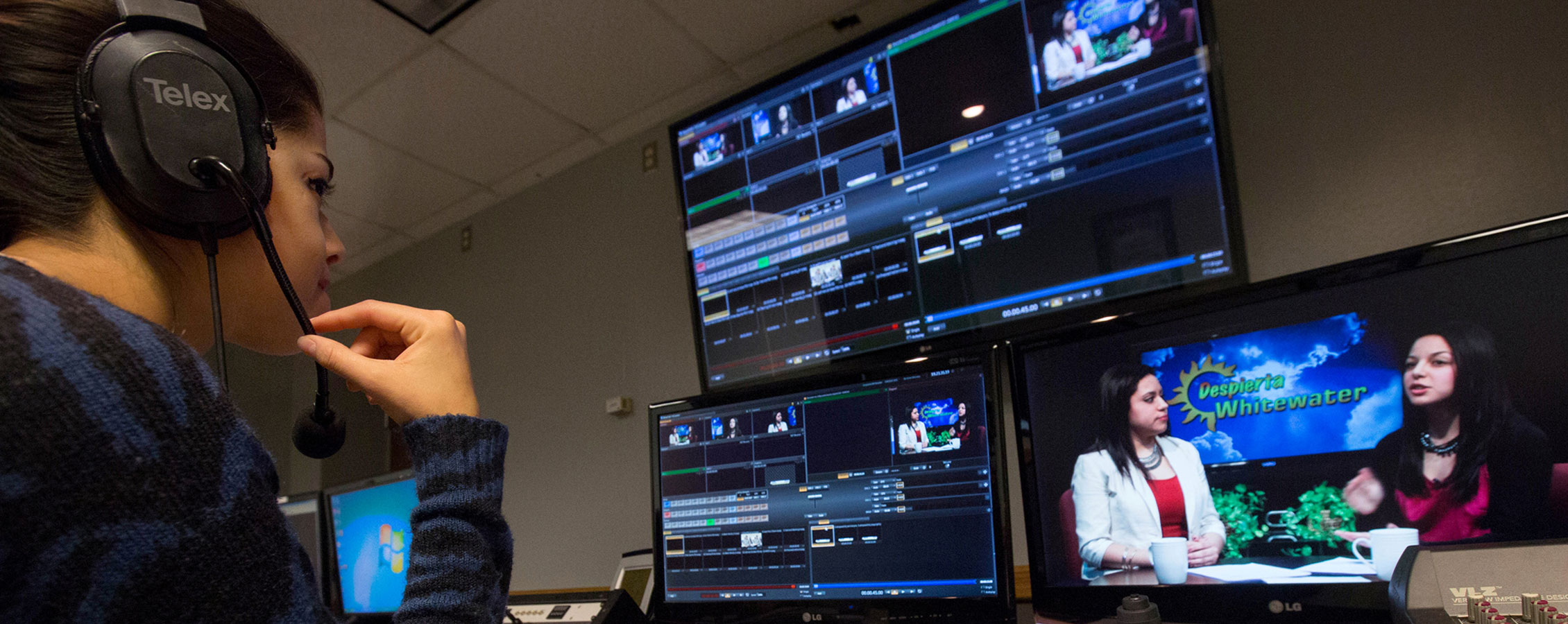 Student works behind the scenes during a TV broadcast.