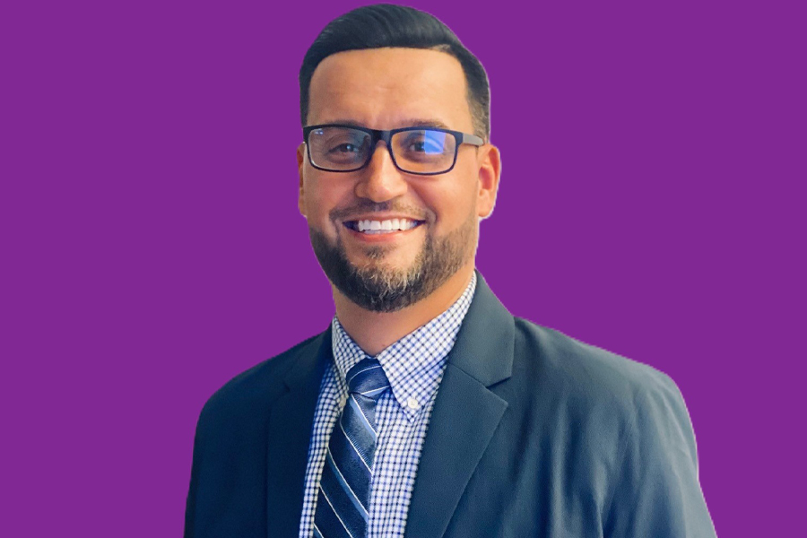 Photo of Rolando De León on a purple background.