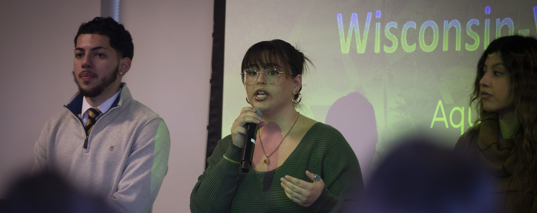 A student speaks in front of a crowd.