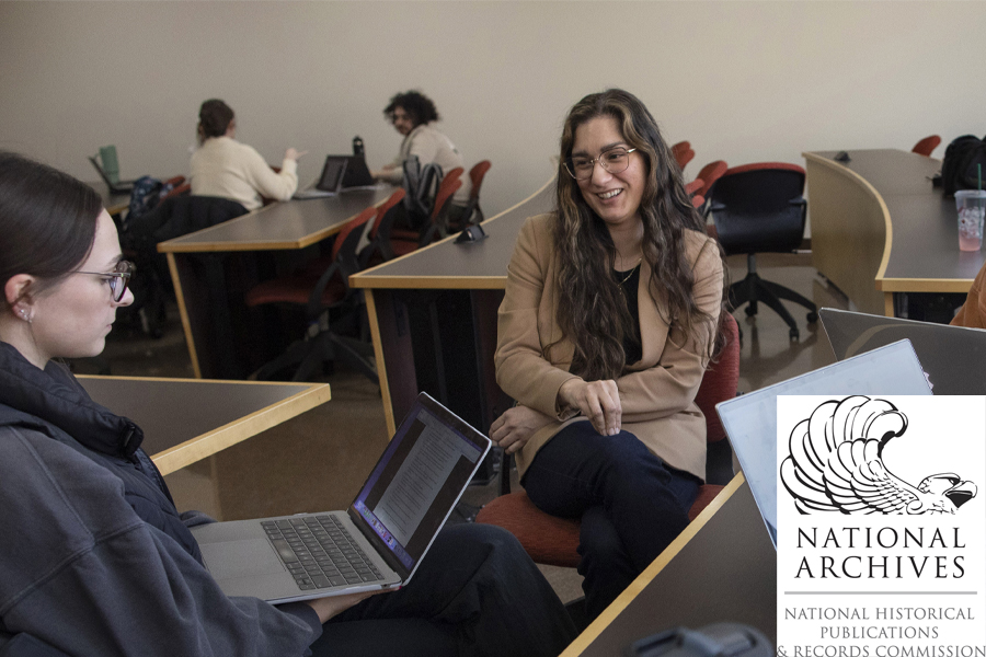 Yesenia Cervera sits with students in a classroom.