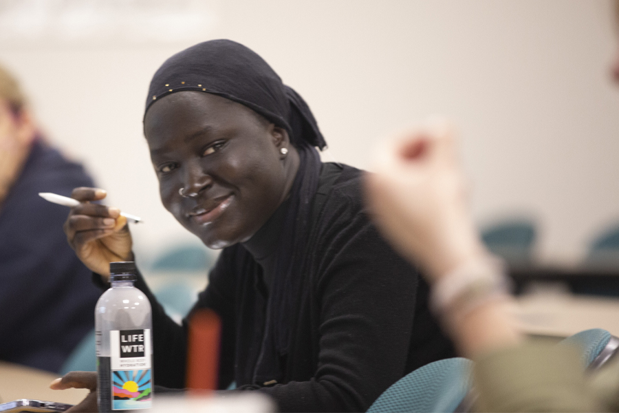 A student smiles in a classroom.