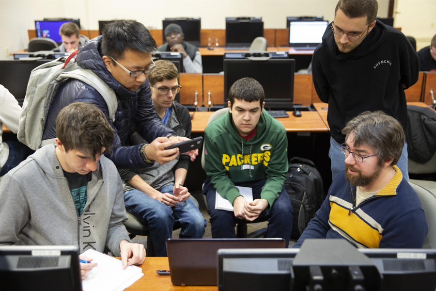 A group of students work together with a faculty member.