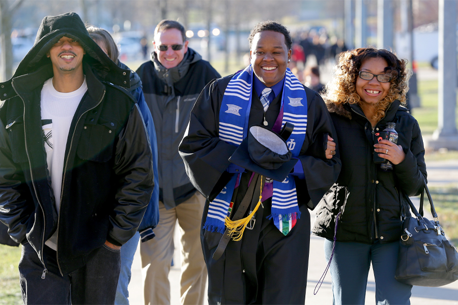 Amos Malone walks to commencement with his family.