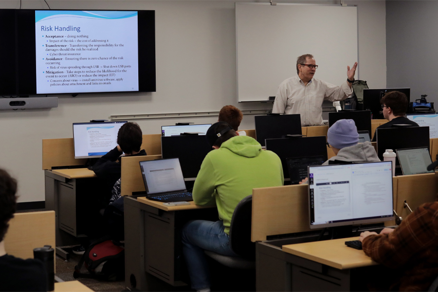 A faculty member speaks to a class.