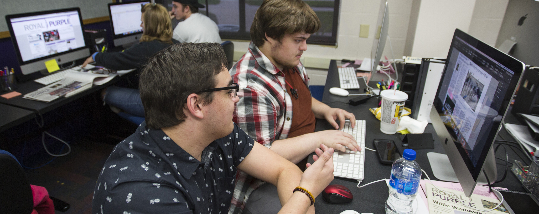 UW-Whitewater English students talk and laugh at computer.