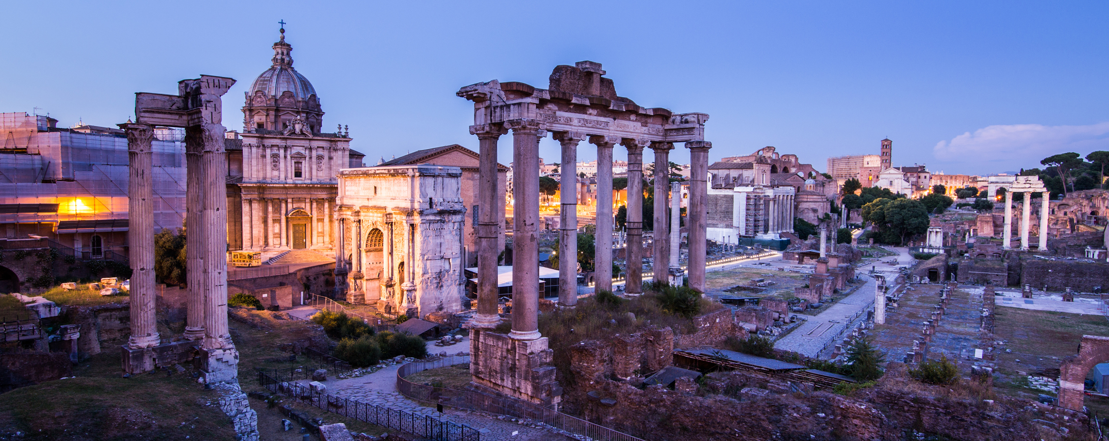 Photo of ancient ruins with columns during a sunset.