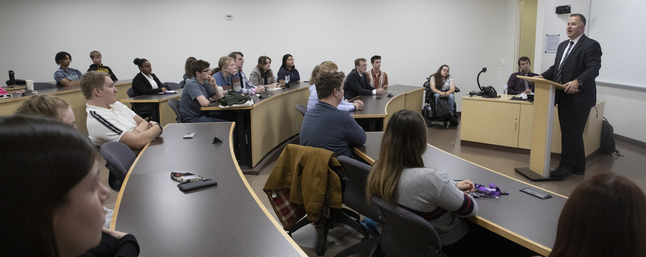 A judge speaks to students in a Hyland Hall classroom.