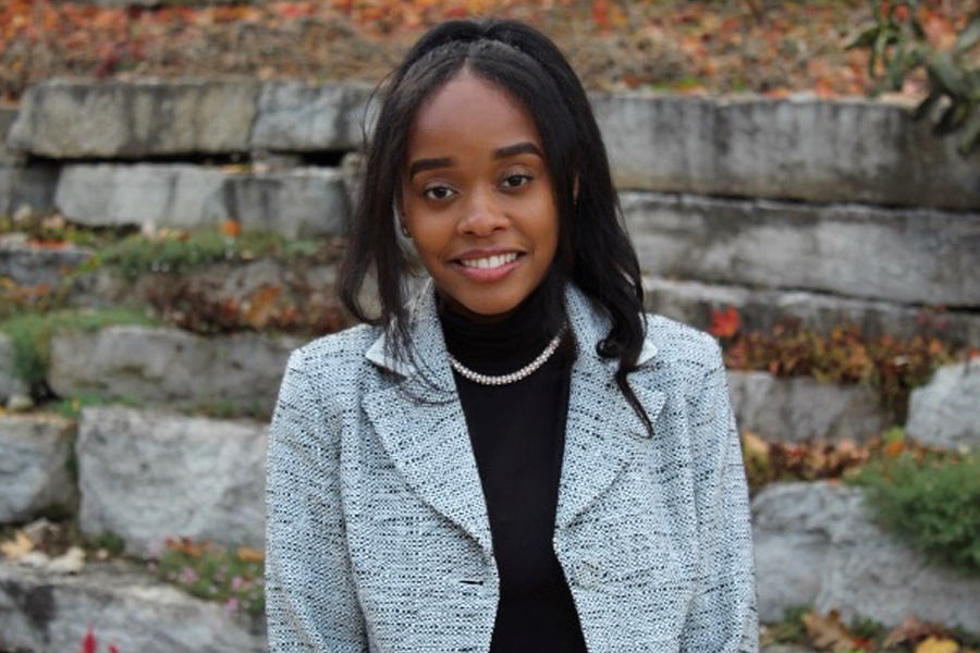 MacKenzie Freeman stands outside in a gray blazer.