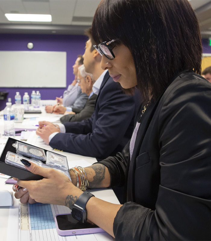 A person in a classroom speaks with their hands.