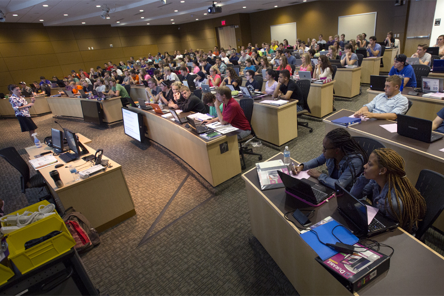 A faculty member speaks in front of a class.