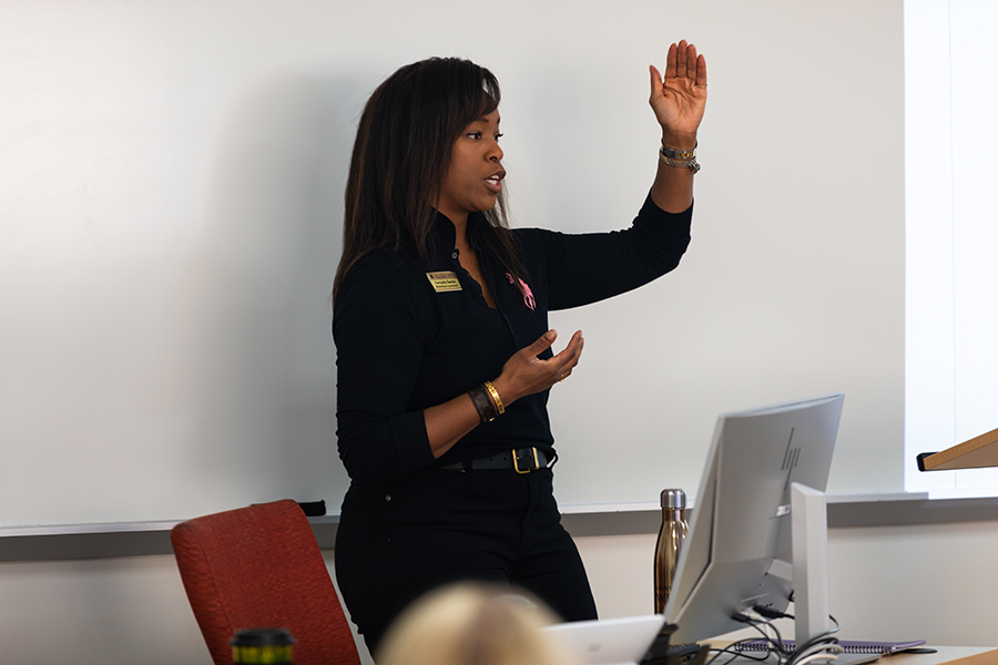 A faculty member speaks at the front of class.