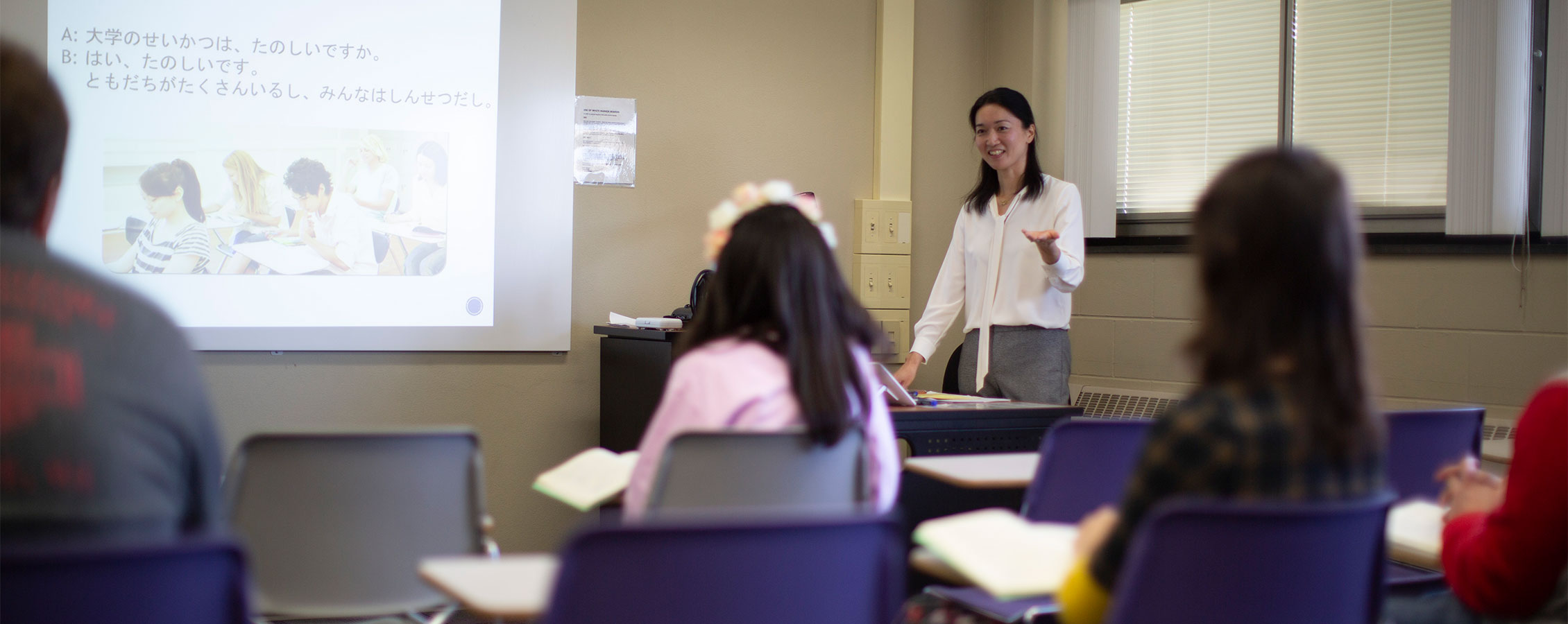 A faculty member stands in front of the class.