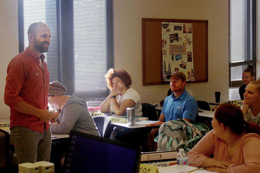 A faculty member teaches Spanish 1 to students in a classroom.