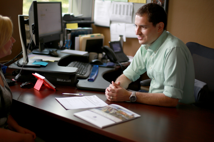 JP Villavicencio sits at a desk.