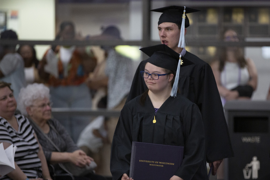 Students in the LIFE program line up for graduation in their caps and gowns.