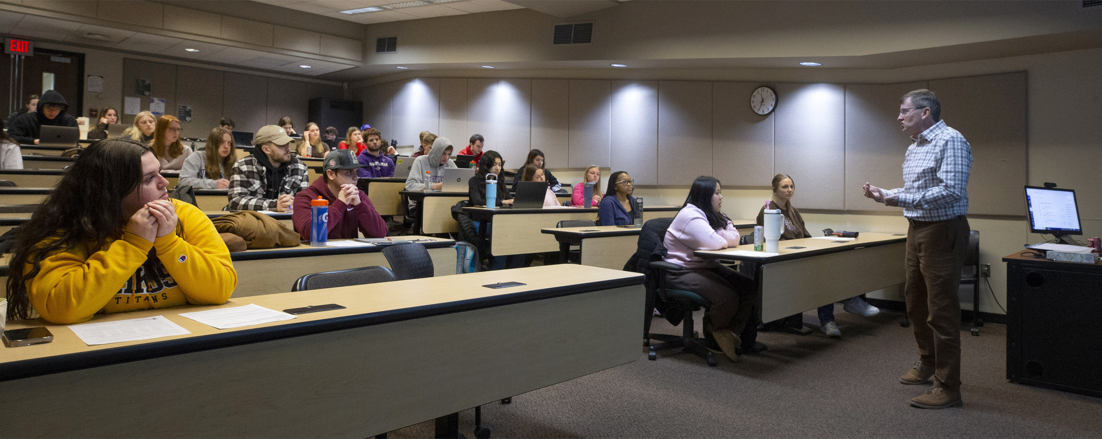 A faculty member teaches at the front of a special education class.