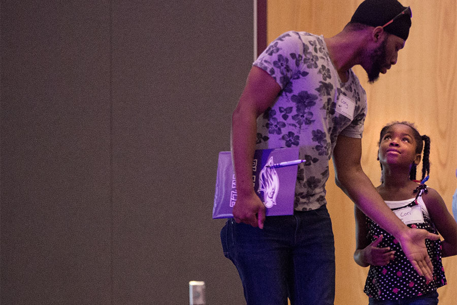  A father directs his daughter during an orientation.