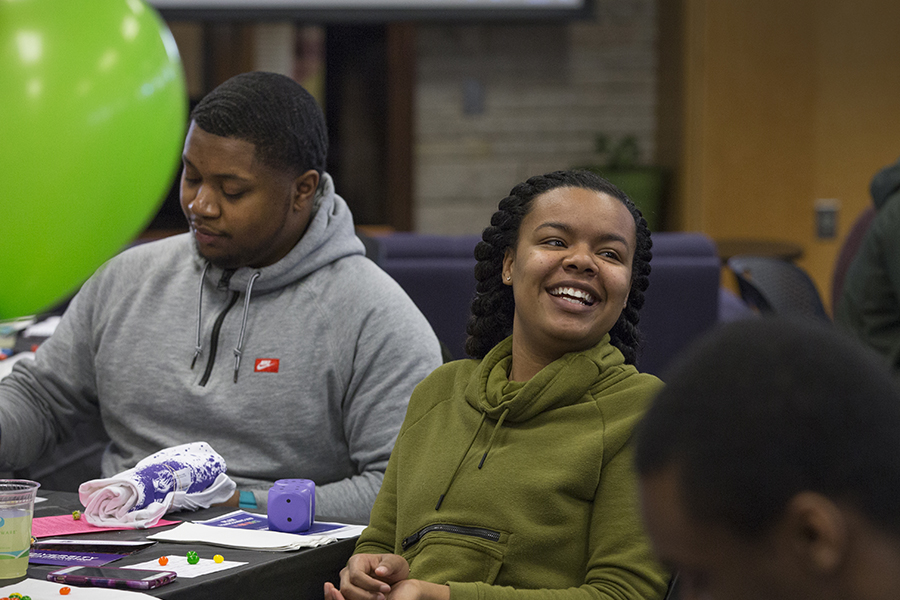 Two student sit and laugh together.