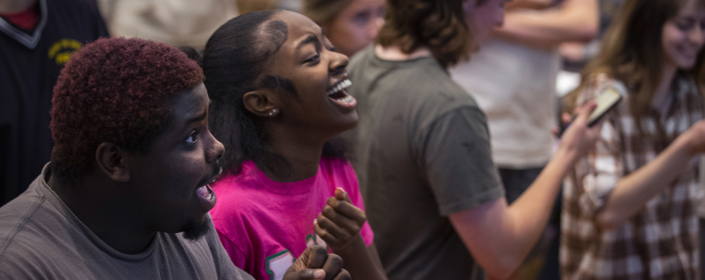 Two students laugh together at a campus event.