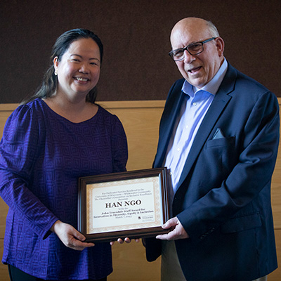 Truesdale Award being held by two people