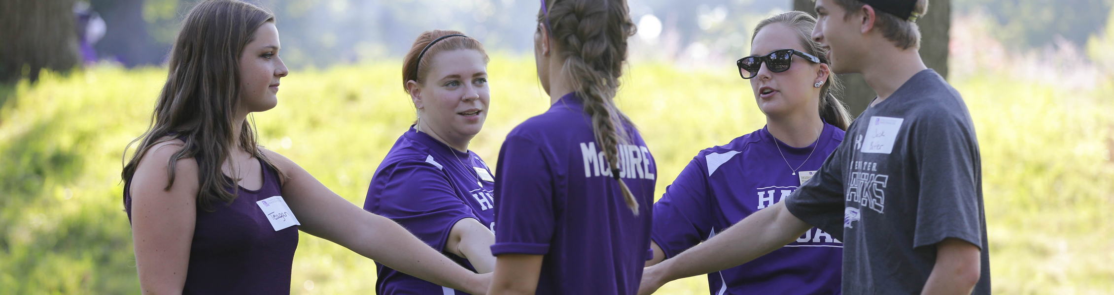 People holding hands out in circle