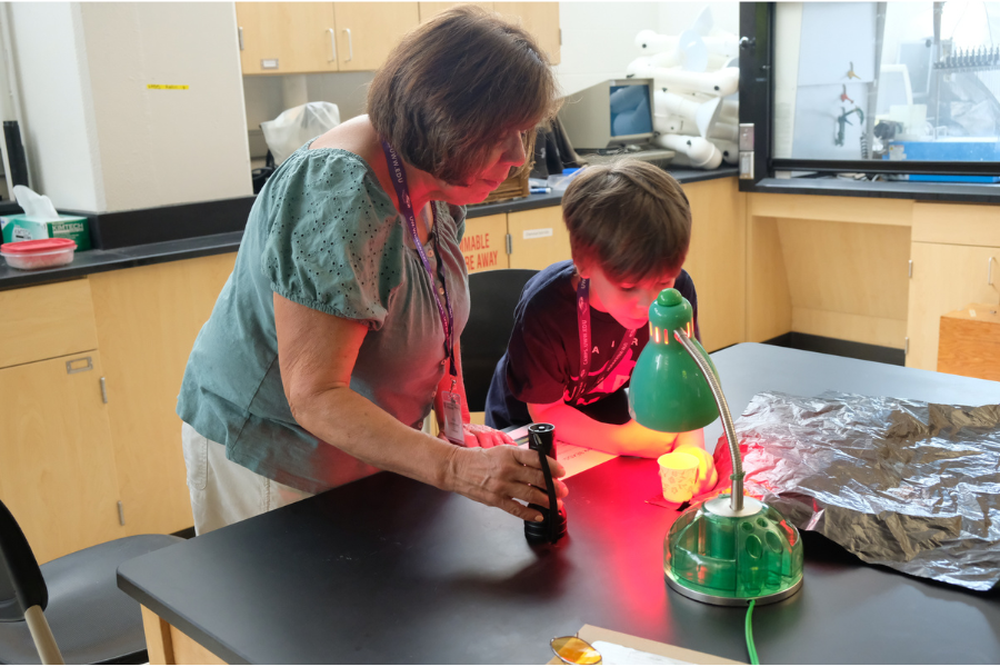 Grandparent helps his grandchild with a project