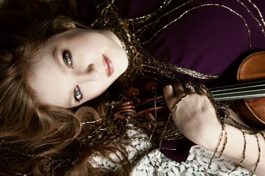 Rachel Pine lays with violin in hand | Photo downloaded from Rachel Pine Press Release Kit