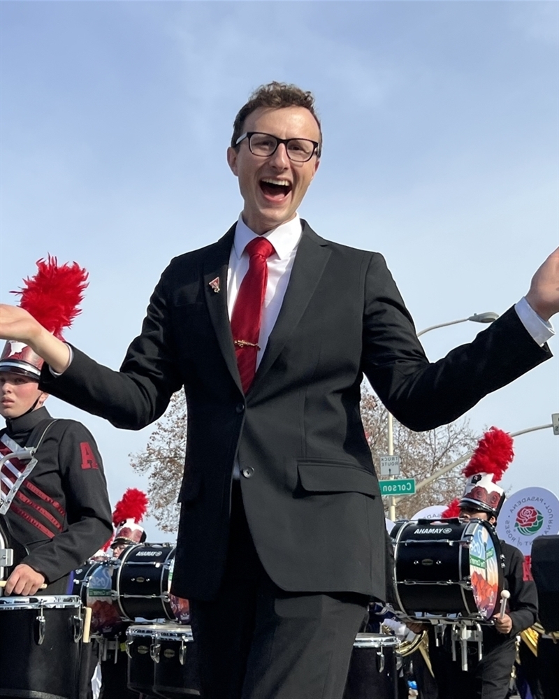 Guest artist smiles in parade with his band