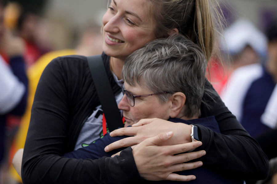 UW Whitewater Impact To Community as community members hug