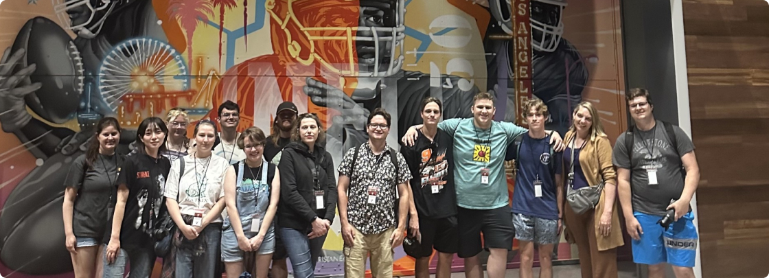 Students taking picture in font of sports art in LA