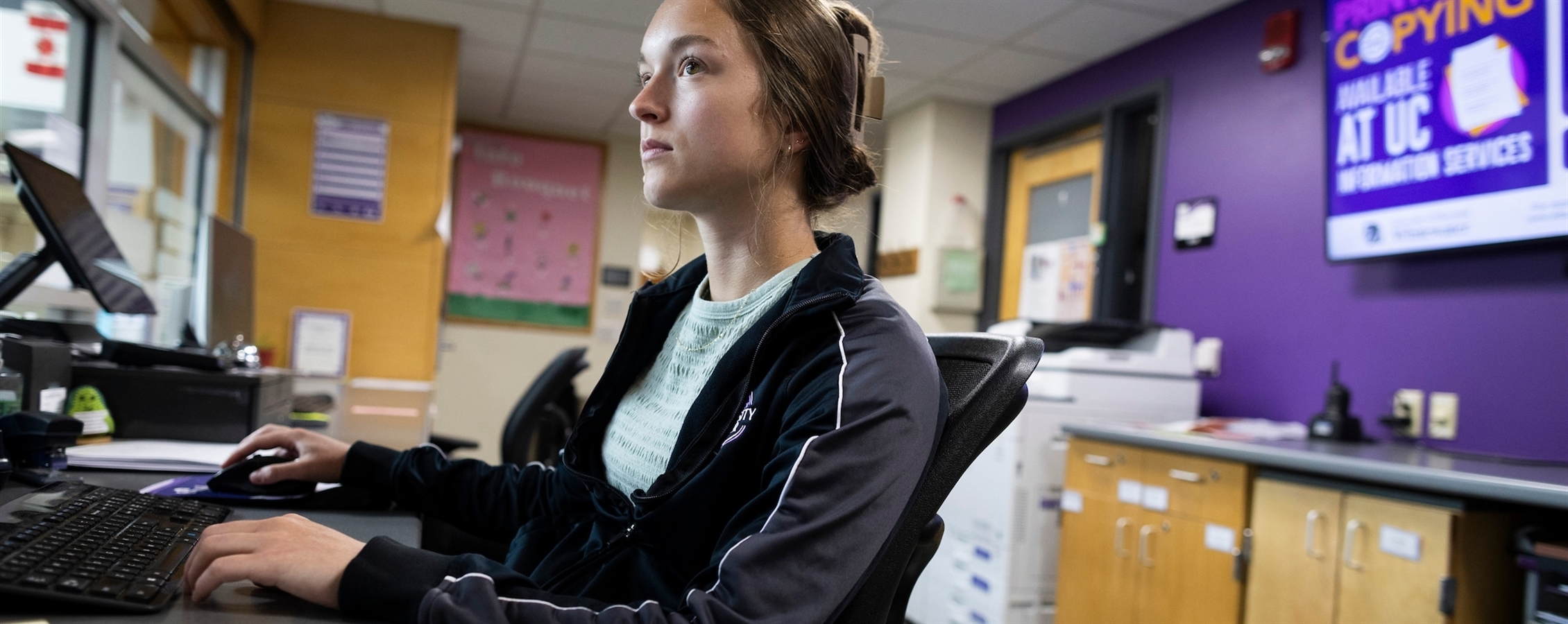 Ellie working on a computer in the University Center
