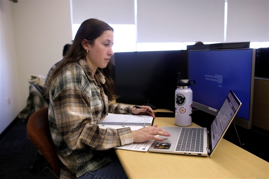 Student working on a computer in the Hyland Hall