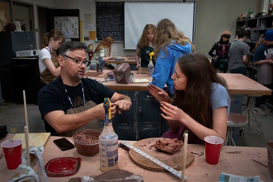 Student making pottery with instructor: UW-WHITEWATER PHOTO/CRAIG SCHREINER