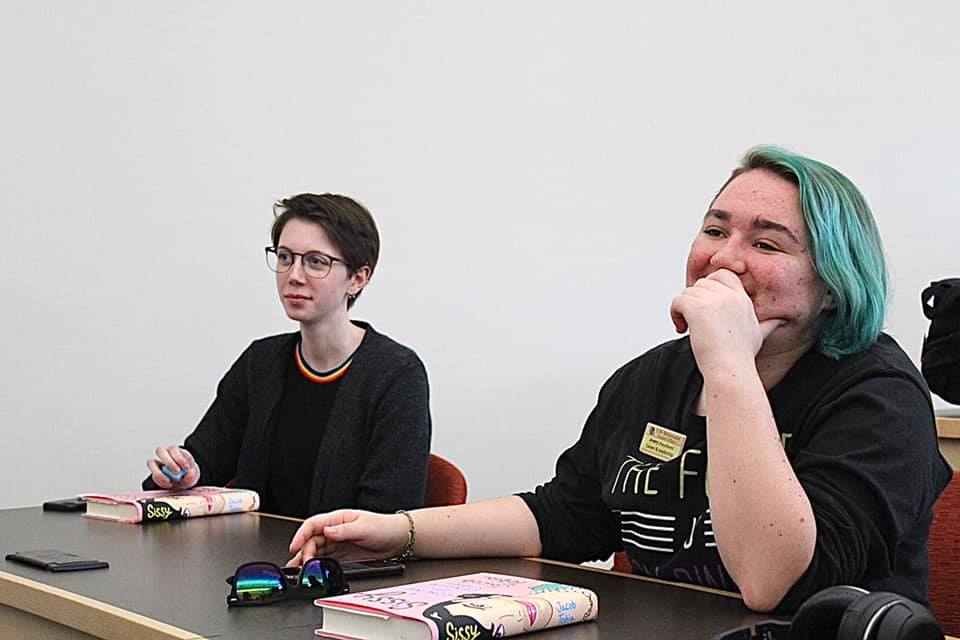 Two students in a class while reading Jacob Tobia's memoir. 