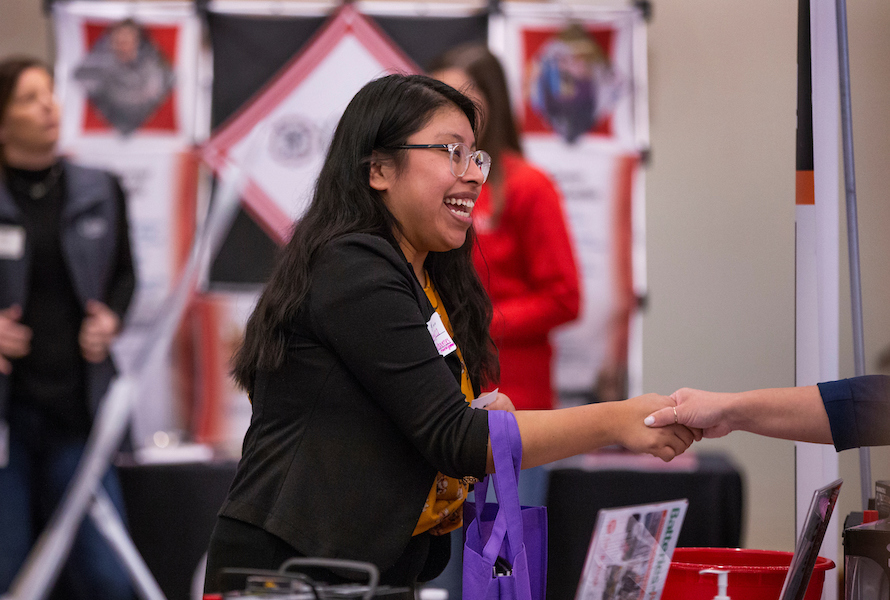 Student talking to recruiters at the University of Wisconsin-Whitewater campus career fair.