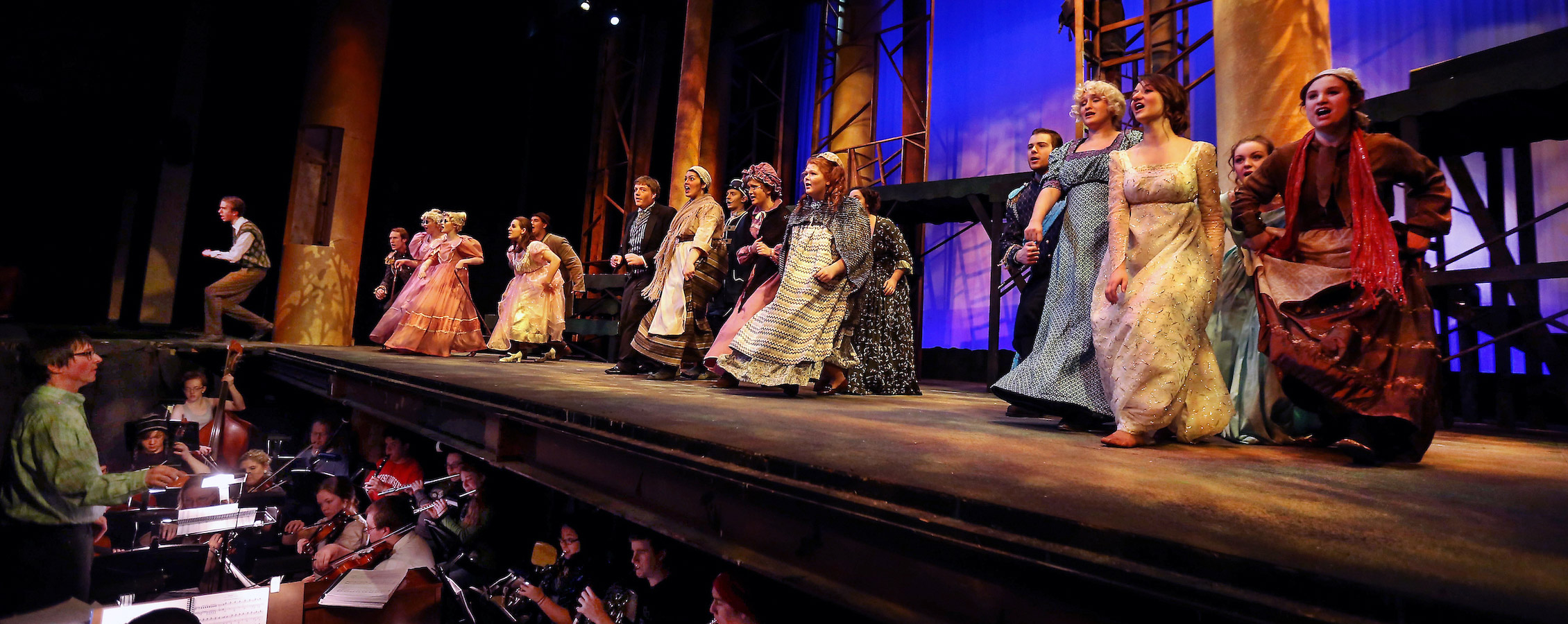 Whitewater students sing at end of stage in Barnett Theatre