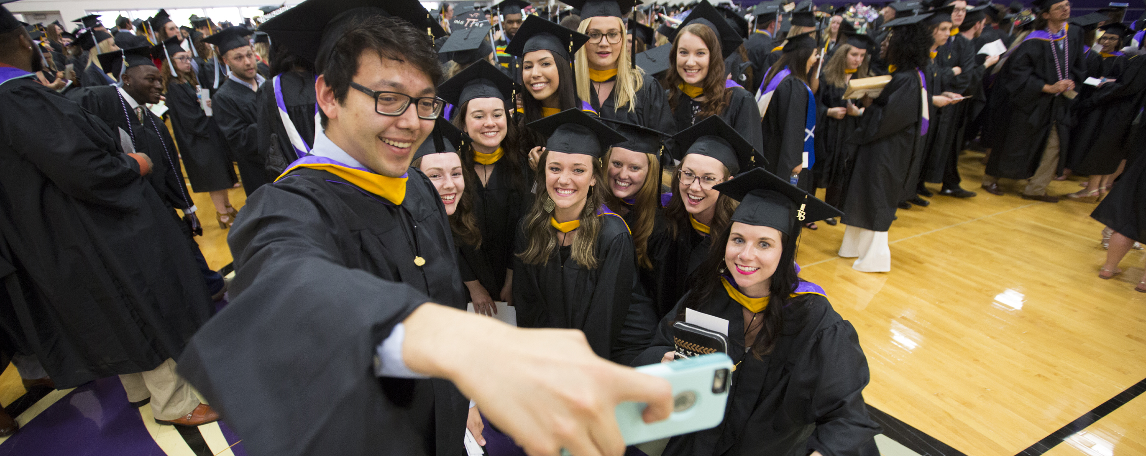 Students gather for a selfie at Commencement.