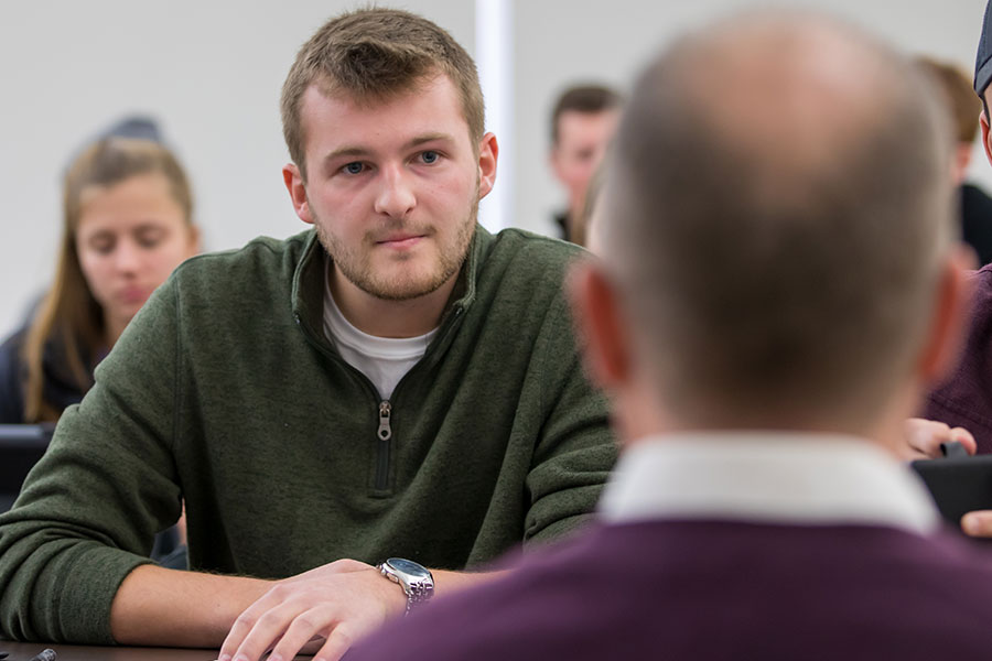 student listening to a professor