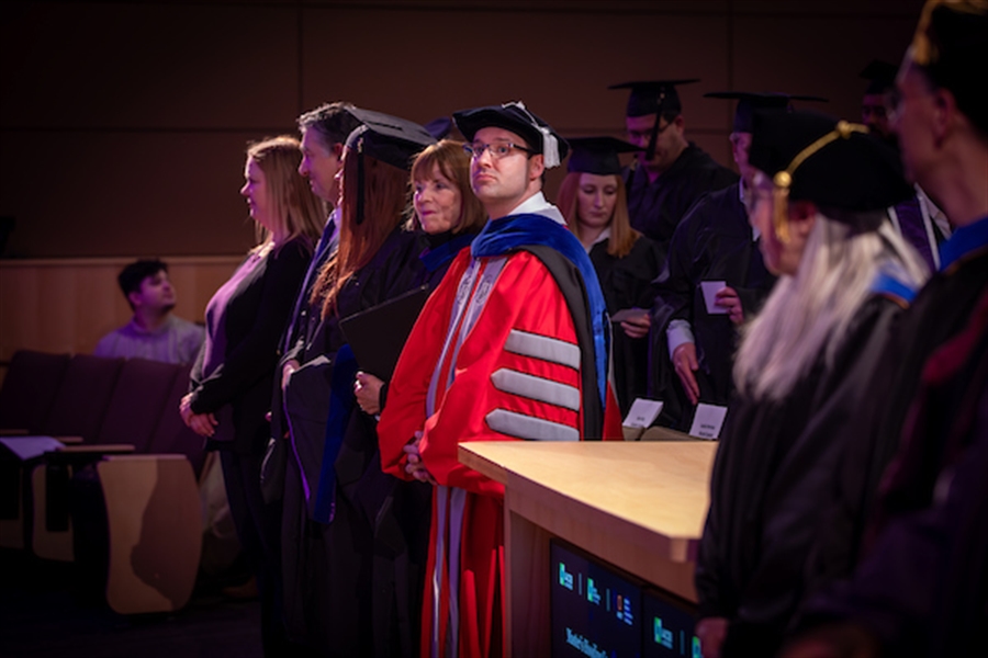 Professor shake hands with DBA student