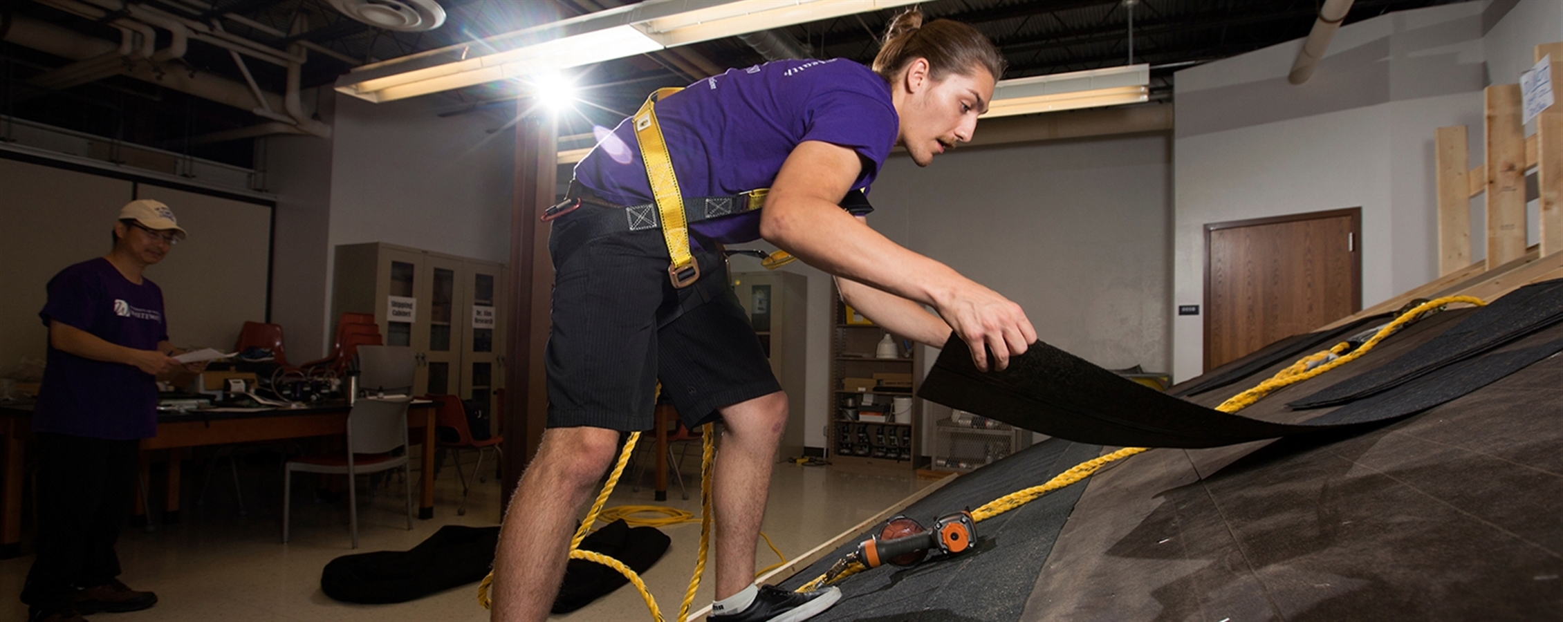 Connor Carrington ‘17, works on the original roofing workstation in the Ambrose Health Center