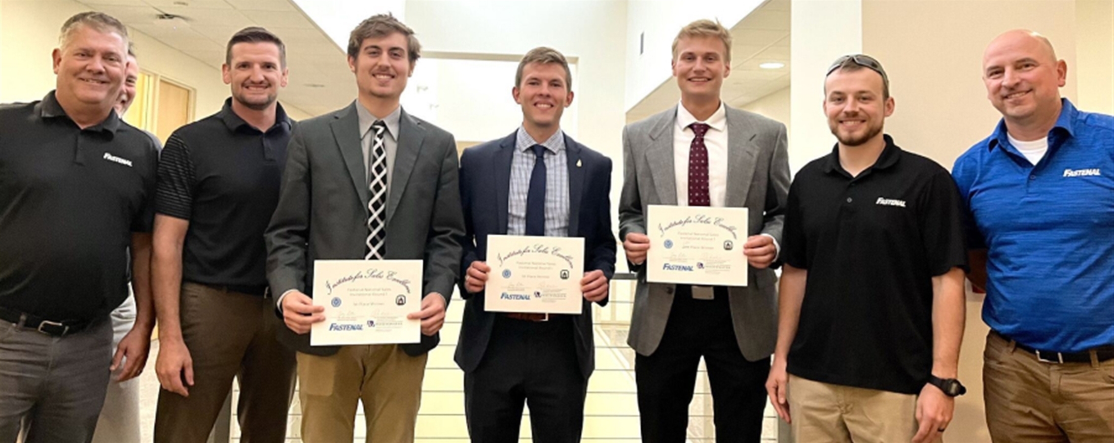 Round 1 winners Garrett Dobbertin, Jack Dummer, and Noah Bulgrin (left to right), alongside representatives from Fastenal. 