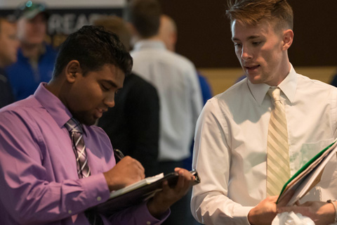 Jake Griffith, left, and mentor Benjamin Brotz walk the floor of CNH Industrial's plant in Sturtevant, Wisconsin.