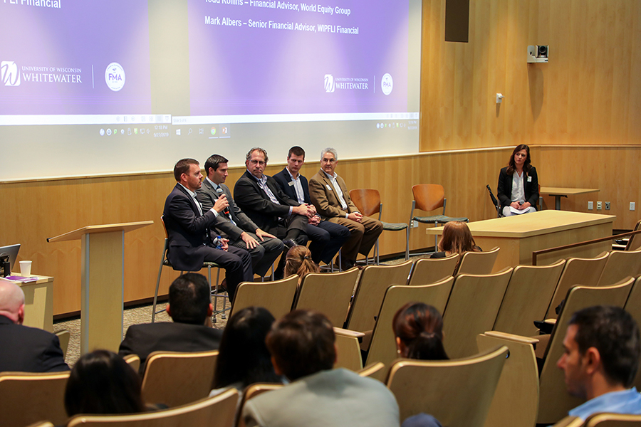 Financial professionals speak to students in Timmerman Auditorium.